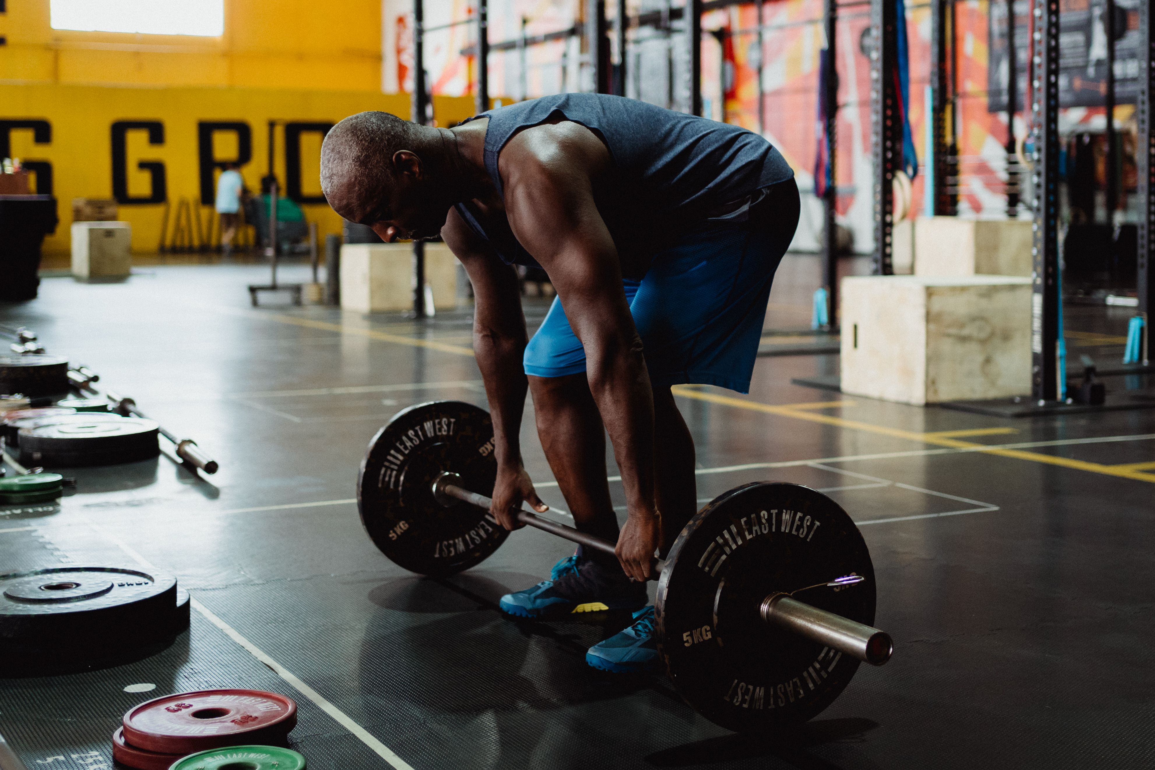 Athlete training with battle ropes in a dark gym